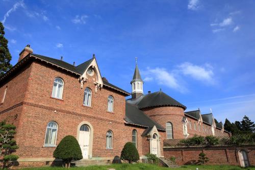 a large brick building with a tower on top of it at Tokyu Stay Hakodate Asaichi Akarinoyu in Hakodate