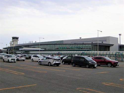 a parking lot with cars parked in front of an airport at Tokyu Stay Hakodate Asaichi Akarinoyu in Hakodate