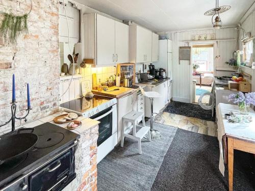 a kitchen with white cabinets and a counter top at 4 person holiday home in FURUBY-By Traum in Fagereke