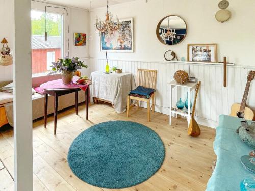 a living room with a blue rug and a table at 4 person holiday home in FURUBY-By Traum in Fagereke