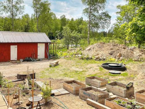a garden with a red shed and a garden sidx sidx sidx at 4 person holiday home in FURUBY-By Traum in Fagereke