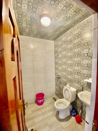 a bathroom with a toilet and a sink at Apparetemt essaouira welecom all in Essaouira