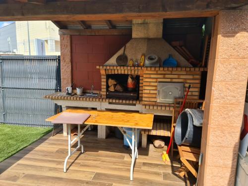 a outdoor kitchen with a table and a stove at Arcos de Valdevez, Recanto da Prova - PNPG in Arcos de Valdevez
