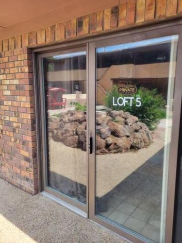 a glass door of a store with a sign on it at Alpine Country Club Lofts in Alpine