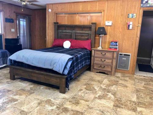 a bedroom with a large bed and a night stand at Alpine Country Club Lofts in Alpine