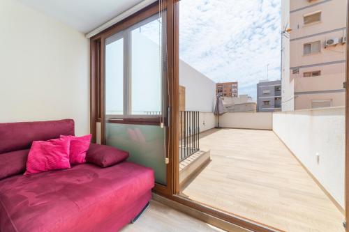 a living room with a couch on a balcony at Las Terrazas de Casa Gómez in Almería