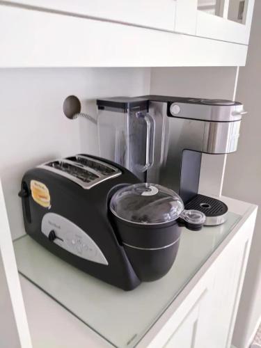 a black blender sitting on top of a counter at Private, Spacious, & Bright Home in Calgary