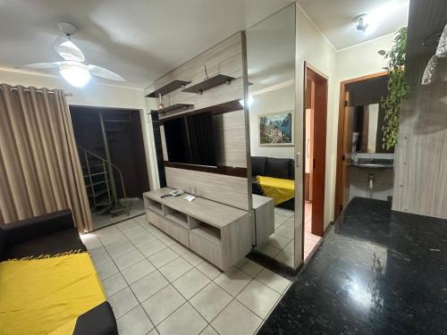 a bathroom with a sink and a large mirror at Thermas Paradise Cobertura 2 suítes e churrasqueira in Rio Quente