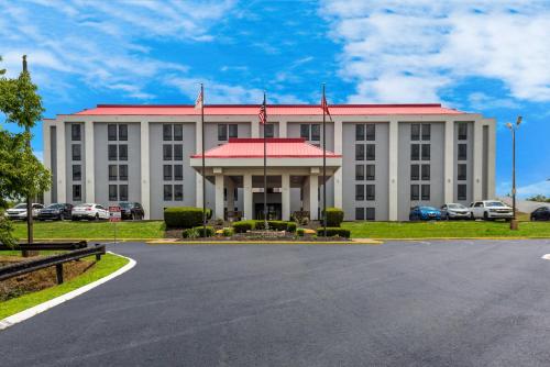 a large white building with a red roof at Red Roof Inn Nashville - Music City in Nashville