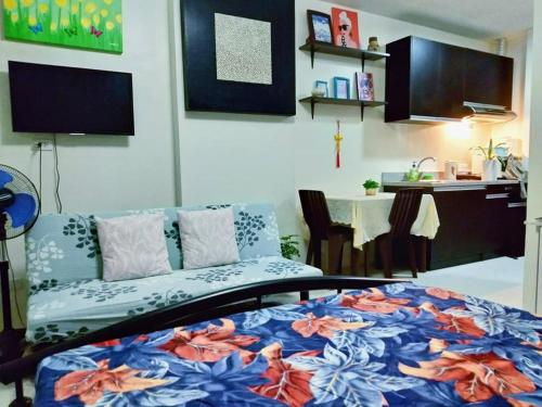 a living room with a bed and a table with a dining room at Arthomes BB3 in Mandaue City