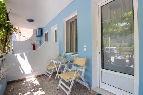 a room with a table and chairs and a window at Studios Liolios #2 in Skala Potamias