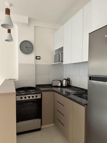a kitchen with a stove and a clock on the wall at Hermoso Depto in Corrientes