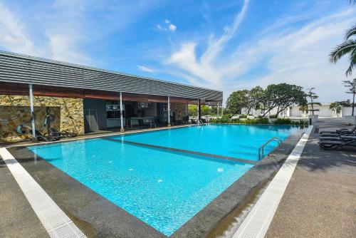 a large blue swimming pool in front of a building at Premiere Hotel in Klang