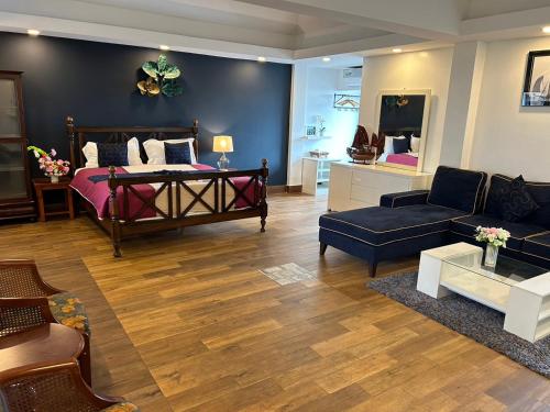 a living room with a bed and a couch at The One Sabai Living Pattaya in Pattaya Central