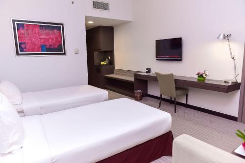 a hotel room with two beds and a desk at Premiere Hotel - Complimentary Shuttle to Klang Wholesale Market in Klang