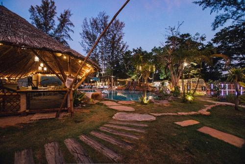 a resort with a swimming pool at night at Dugong Village-Green Hotel in Pak Meng