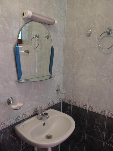 a bathroom with a sink and a mirror at Guest House Lazur in Obzor