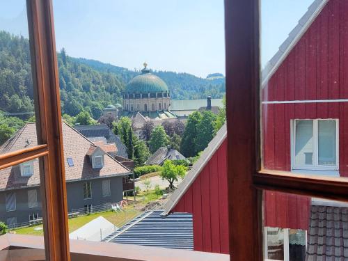 a view from a window of a red building at Ela Vital Ferienwohnung in St. Blasien