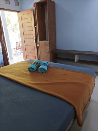 Ένα ή περισσότερα κρεβάτια σε δωμάτιο στο Merendeng Hostel Kuta