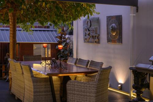 a wooden table and chairs in a restaurant at Bakers Retreat in Hobart