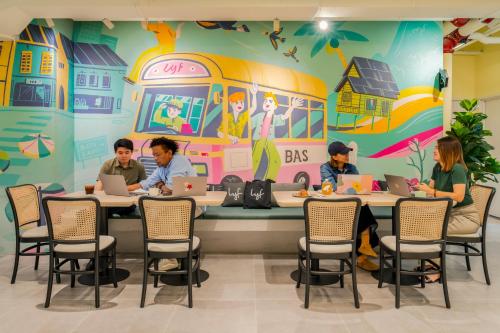 a group of people sitting at tables in a school cafeteria at lyf Chinatown Kuala Lumpur in Kuala Lumpur