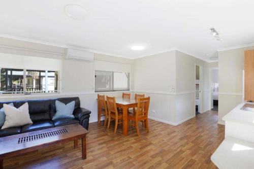 a living room with a couch and a table at Reflections North Haven - Holiday Park in North Haven