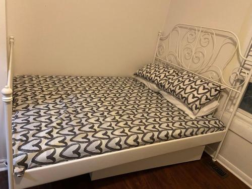 a white bed with a black and white mattress at BUDGET Triple Room with En Suite Bathroom 36A in Toronto