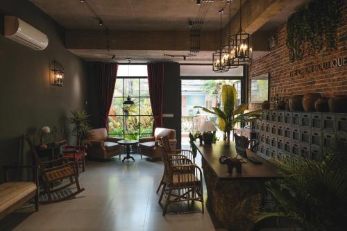 a living room with a table and some chairs at The Chum Boutique in Hue