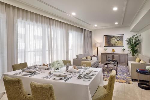 a dining room with a white table and chairs at Jumeirah Jabal Omar Makkah in Makkah