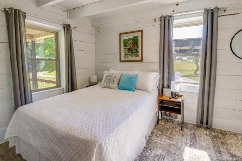 a bedroom with a white bed and a window at Jefferson City Getaway - 3 Mi to Cherokee Lake! in Jefferson City