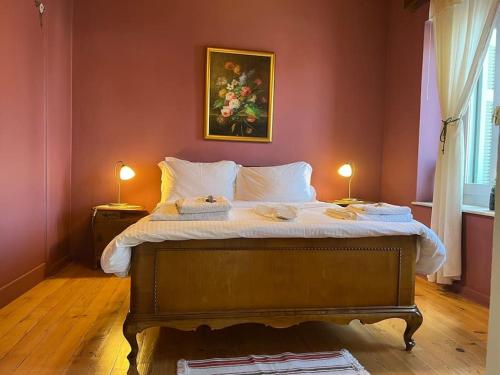 a bedroom with a bed with two lamps on it at Guesthouse Simou with view 3 bedrooms in Arachova