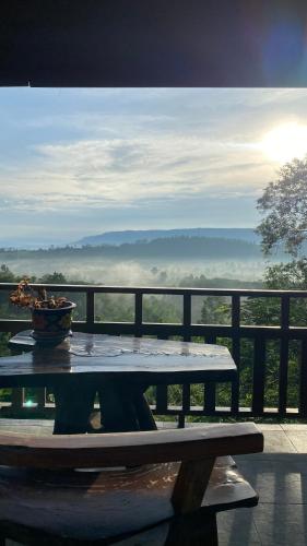 a table with a bowl on top of a balcony at ภูคำฮ้อมคลิฟฟ์ลอดจ์ แอนด์ โฮมสเตย์ Phu come home cliff Lodge & Homestay in Ban Phu Hi