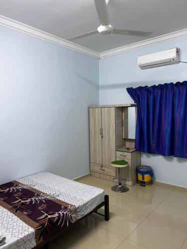 - une chambre avec un lit et un mur bleu dans l'établissement VINDRA HOMESTAY, à Bidur