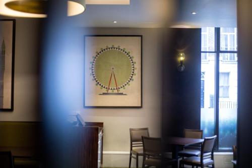 a dining room with chairs and a picture on the wall at President Hotel in London