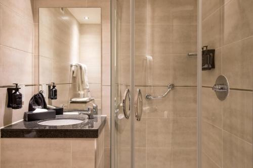 a bathroom with a shower and a sink at President Hotel in London