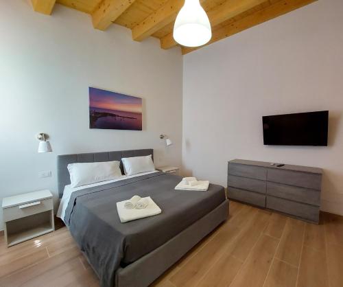 a bedroom with a bed and a flat screen tv at Residence Del Tellaro in Noto Marina