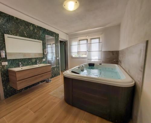 a large bathroom with a large tub and a sink at Residence Del Tellaro in Noto Marina