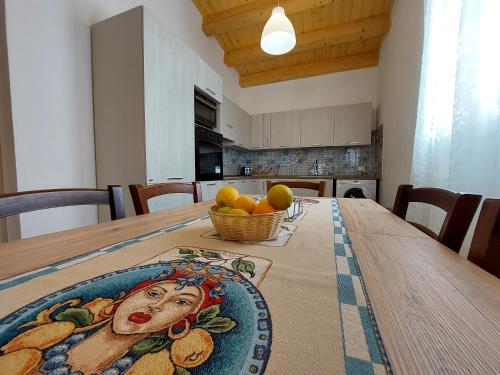 a dining room table with a bowl of fruit on it at Residence Del Tellaro in Noto Marina