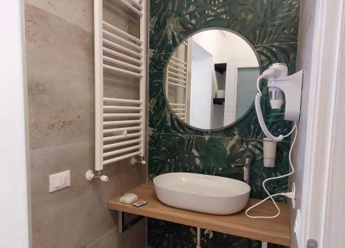 a bathroom with a sink and a mirror at Residence Del Tellaro in Noto Marina