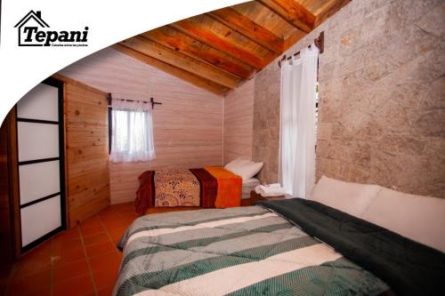 1 Schlafzimmer mit 2 Betten in einem Zimmer in der Unterkunft Cabañas Tepani in Tzicuilán