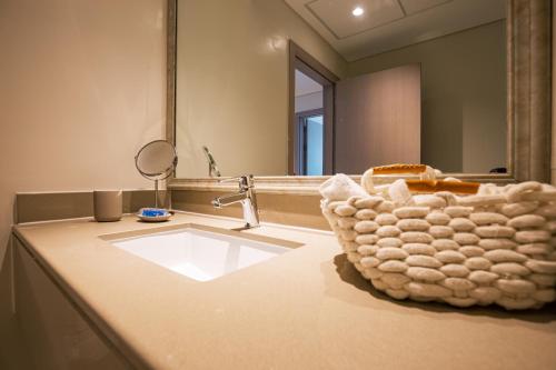a bathroom with a sink and a mirror at Top Rated Family Suite - Yas in Abu Dhabi