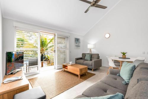 a living room with a couch and a table at 7 Pelican Beach Resort in Noosaville