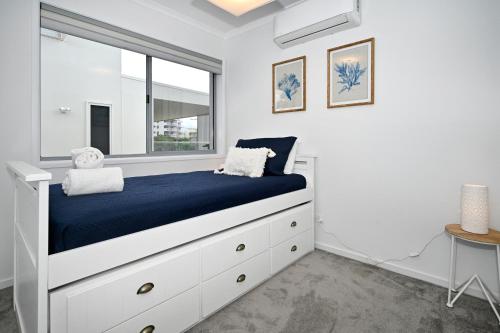 a bedroom with a bed and a window at Stunning, Beachfront Dream Home - ZA3 in Buddina