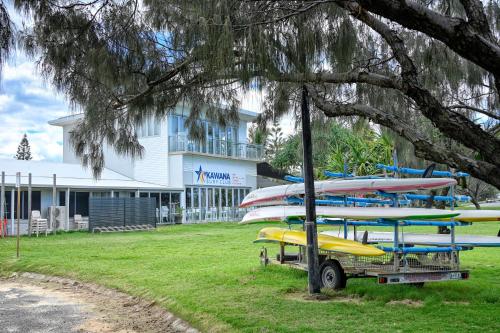 a group of surfboards on a rack in front of a building at Stunning, Beachfront Dream Home - ZA3 in Buddina