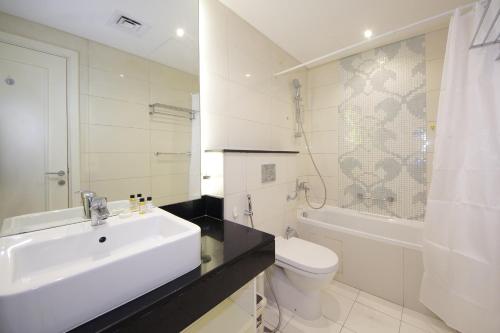 a white bathroom with a sink and a toilet at SHH - Spacious 2 Bedroom Apartment in Capital Bay Tower B, Business Bay in Dubai