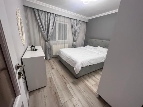 een kleine slaapkamer met een bed en een raam bij EBI Apartment in Cluj-Napoca