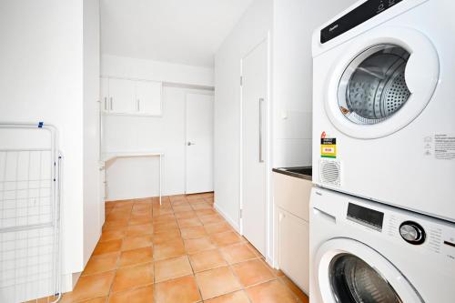 a laundry room with a washer and dryer at Stunning Mooloolaba Waterfront Home -10 guests ZB1 in Mooloolaba