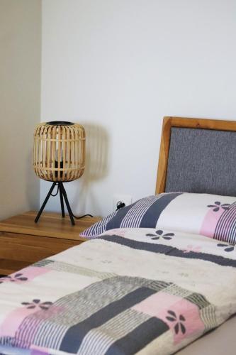 a bedroom with a bed and a lamp on a table at Hájenka hraběte Buquoye in Kaplice