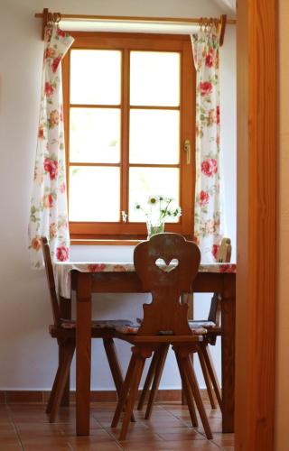 a table with a chair in front of a window at Hájenka hraběte Buquoye in Kaplice