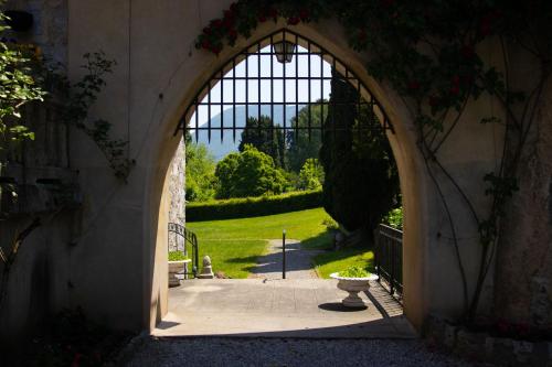 an archway in a building with a garden in the background at Cabana & Nuit de Château au bord du Lac Léman in Lugrin